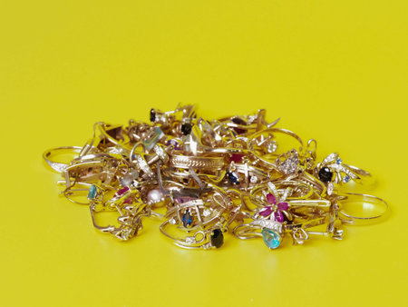Jewelry with precious stones are on a yellow background.の写真素材