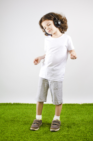 Music and technology concept.Caucasian little boy dancingの写真素材