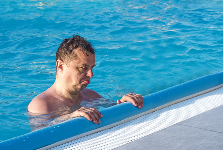 Sad man in the poolの写真素材