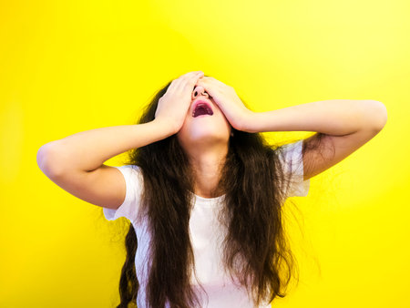 Young beautiful young woman mistaken, isolated studio shot on backgroundの写真素材