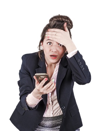 Shocked executive director of a young woman, dressed in black elegant clothes, surprised by information during a telephone conversationの写真素材