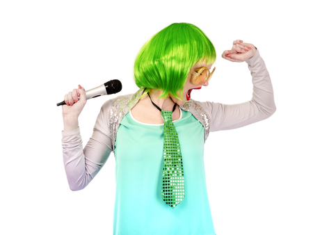 The beautiful singer is recording at the studio. It has a bright wig.Isolated on whiteの写真素材
