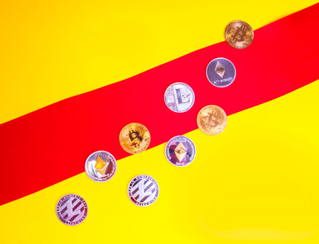 Crypto currency crosses the red line on a yellow background. Metal gold money bitkoynju.