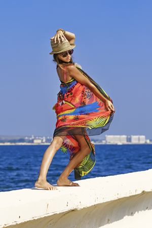 Young and beautiful girl have a seasonal winter vacation on the beach in exotic countryの写真素材