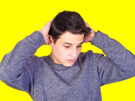 Portrait of a thoughtful young man, isolated on a light background