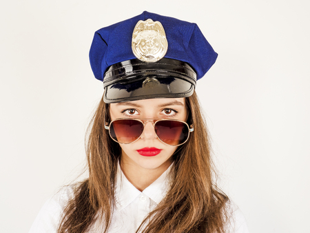 Portrait of long-haired young police woman, isolated on white backgroundの写真素材
