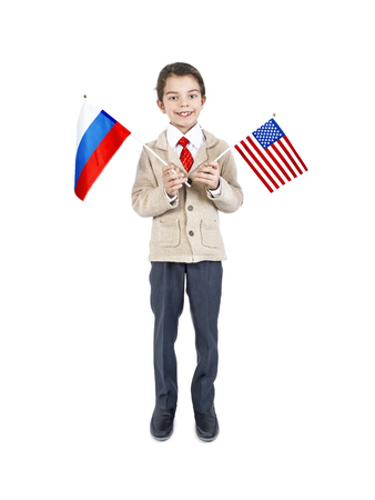 Charming little brunette guy holding the flag of the USA and Russia, isolated on whiteの写真素材