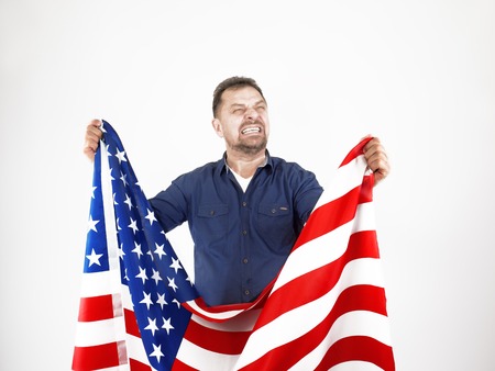 Depressed mature man with the flag of the United States, despair conceptの写真素材