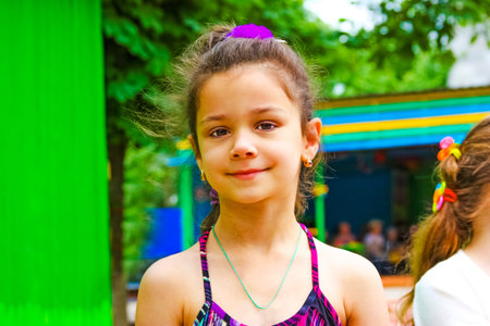 Portrait of cute little toddler girl in bright clothes on a playground.の写真素材