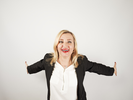 Attractive mature woman relax and dance on copy space. Portrait of happy girl imitating a flight forward with the help of her arms thrown back. Constant self-improvement conceptの写真素材