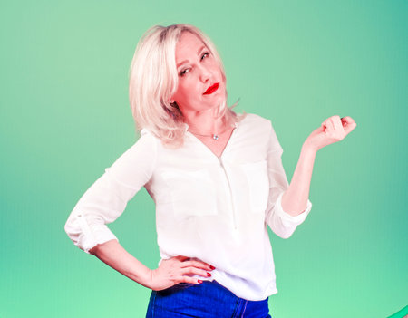 Pissed off by an angry angry middle-aged pessimistic woman with a bad attitude of thinking looks at you Negative emotions of a person's facial expression of a feeling of reactionの写真素材