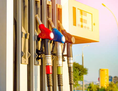 gun for refueling at a gas station on a hot summer day