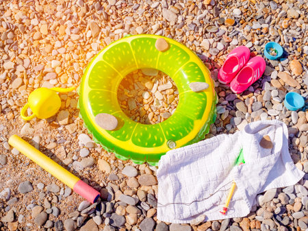 Summer beach holiday vacation accessories on a pebble surface, summertime lifestyle objects in a...