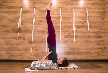 Young attractive woman practicing yoga, standing in Warrior one exercise. Working out, wearing...
