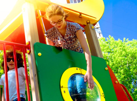 happy children at playground area in summer