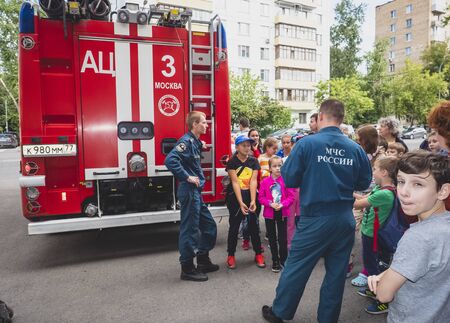 MOSCOW, RUSSIA - AUGUST 07, 2019: Fire station. A fireman explaining his job to children. Fire Station One open family day tour.のeditorial素材