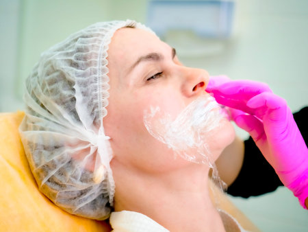 Woman getting  injection in spa. contour plastic. A cosmetologist injects a botulinum toxin to...