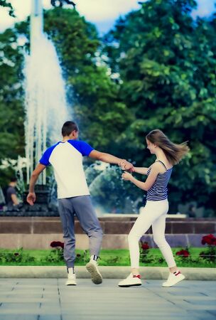 love, relationship, family and people concept - happy couple walking in summer city parkの写真素材