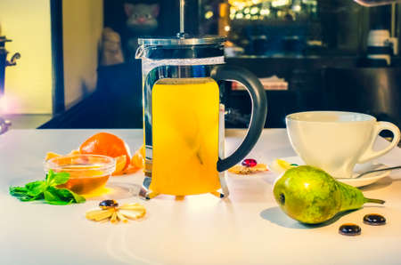Hot citrus tea with lemon, fresh mint and fruit. Tea party with fruit in the restaurantの写真素材