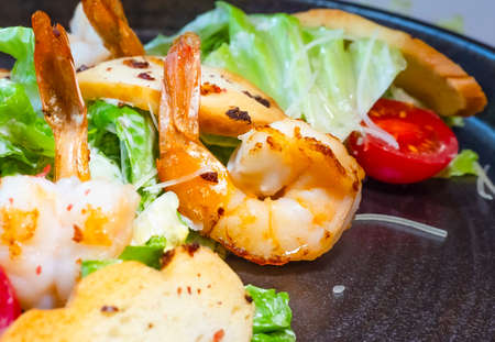 Salad of shrimp, olives, tomato, lettuce and quail eggs. Top viewSelective focus. Super short focus.の写真素材