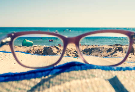 Close-up Of Beach And Sea Seen Through Glasses On Sunny Dayの写真素材