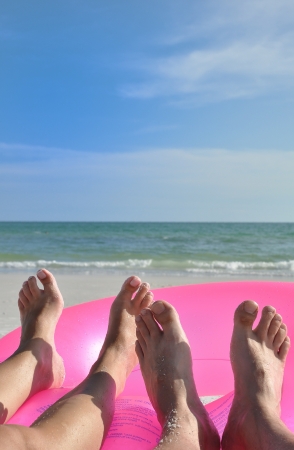 Two beach feet on pink ringの写真素材