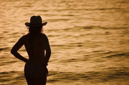 Women with the hat at the oceanの写真素材