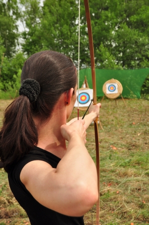Young women training with the bowの写真素材
