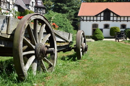 Ancient vehicle with wooden wheels in a farmの写真素材