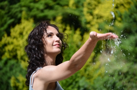Young woman washing hand under the stream of waterの写真素材
