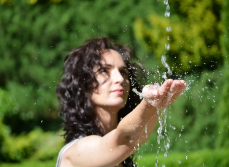 Young woman washing hand under the stream of waterの写真素材