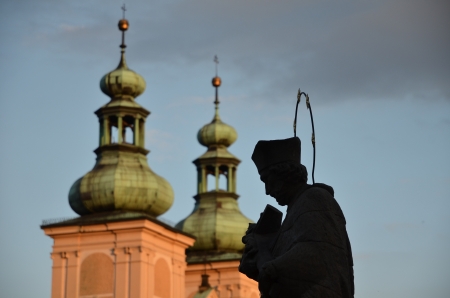 Sculpture priest with Bible in sunshine Klodzk Polandの写真素材