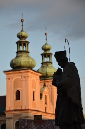 Sculpture priest with Bible in sunshine Klodzk Polandの写真素材