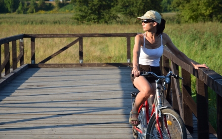 Girl riding bicycle in country sideの写真素材