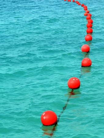 Red buoy row floating seaの写真素材