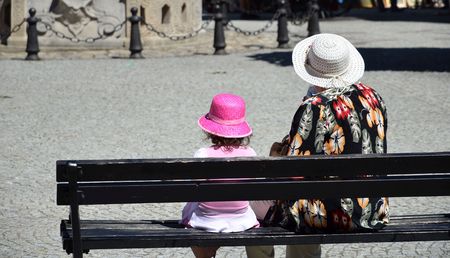 old and young on benchの写真素材