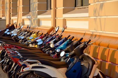 rows of motorbikes parked outside a public building in Ho Chi Minh Cityの写真素材