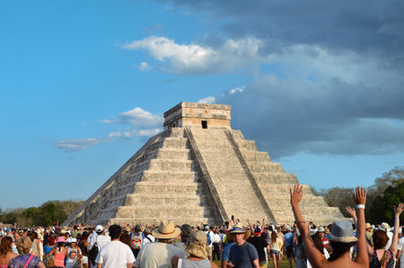 CHICHEN ITZA, MEXICO - MARCH 21,2014: Tourists watching the feathered serpent crawling down the...