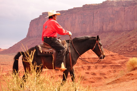 Monument Valley , Utah - September 12: Monument Valley Tribal Park in Utah USA on September 12, 2011. Cowboy on horse in famous tribal park.のeditorial素材
