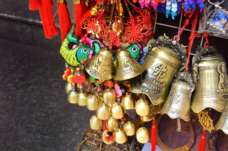 SHANGHAI, CHINA - May 7, 2017 - Decoration coins and bells souvenirs from China on market near Yu Garden, Shanghaiのeditorial素材