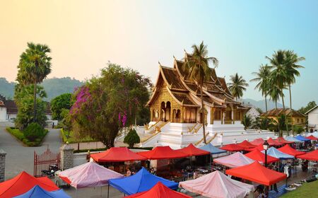 LUANG PRABANG, LAOS - MARCH 23, 2018: The Haw Pra Bang Temple near Royal Palace of Luang Prabang National museum with night marketのeditorial素材