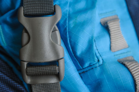 closed grey fastex buckle of blue trekking backpack