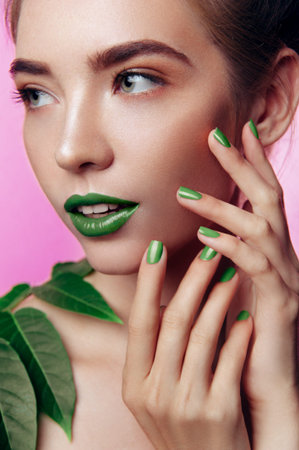 beauty closeup portrait of white young girl in punchy pastel green and pink tones makeup. Vertical photoの写真素材