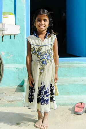 young indian girl with braids smiling in camera in outdoors. vertical photo. 11 february 2018 Puttaparthi, Indiaのeditorial素材