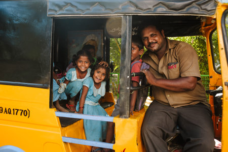23 february 2018 Madurai, India, group of indian schoolgirls smiling to camera in tuk tuk rickshaw