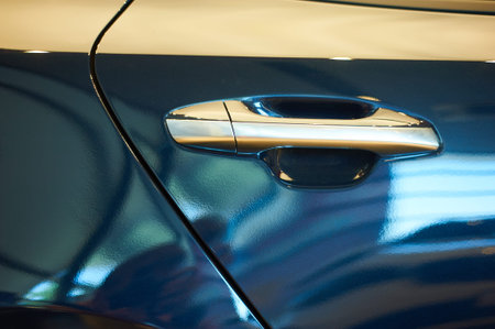 chrome metallic handle of new blue car closeup. auto car showroomの写真素材