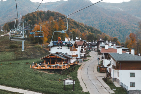 People seats at cableway elevator. Cable car road at Rosa Khutor Resort - Russia, Sochi, 10.10.2018のeditorial素材
