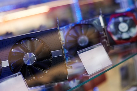 row of many video cards is on sale at showcase in store. graphics chipsets selling concept. mining price increaseの写真素材