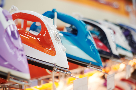 row of many irons is on sale at showcase in store. discount or sell-out conceptの写真素材