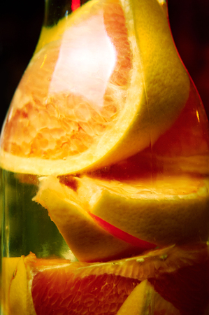 lemonade with orenge slices in bottle. vertical close upの写真素材
